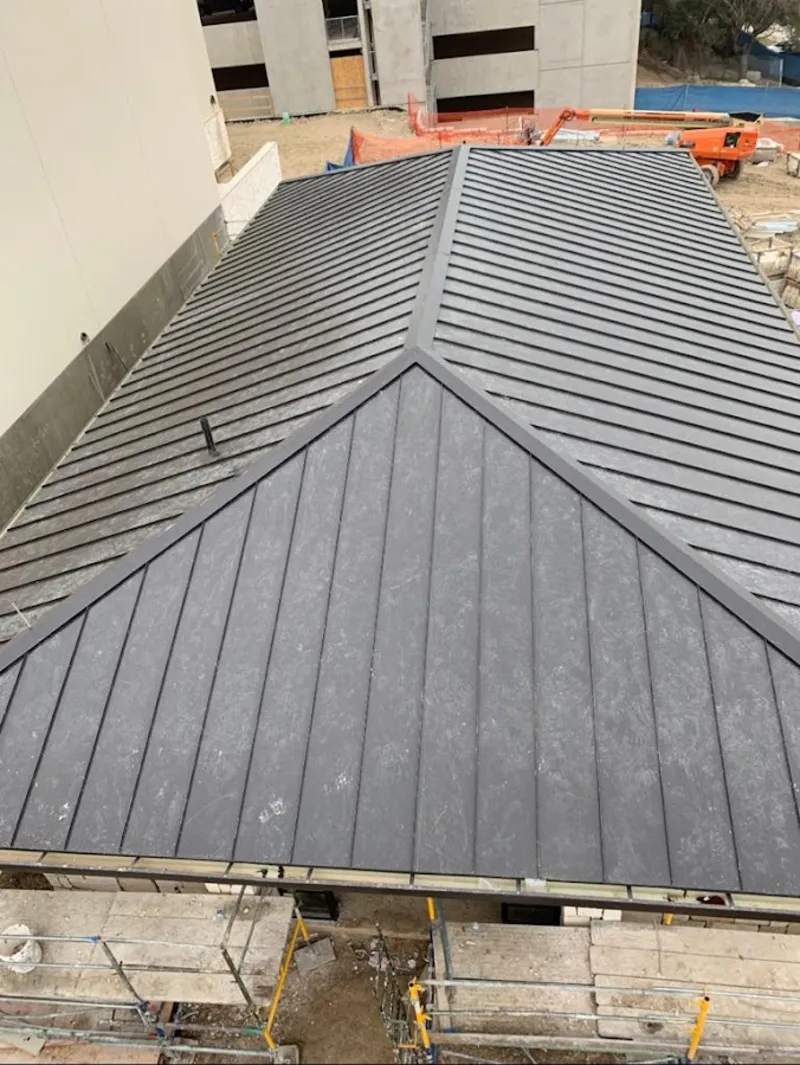 Commercial metal roof construction with crane equipment in Danville